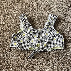 This is a kids bathing suit that has sunflowers on it.